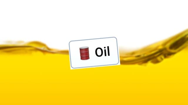Infinite Craft Oil block atop a blurred image of yellow liquid against a white backdrop
